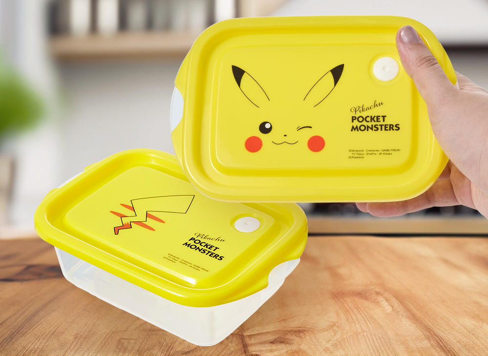 A Pikachu Bento Box sits on a wooden table.
