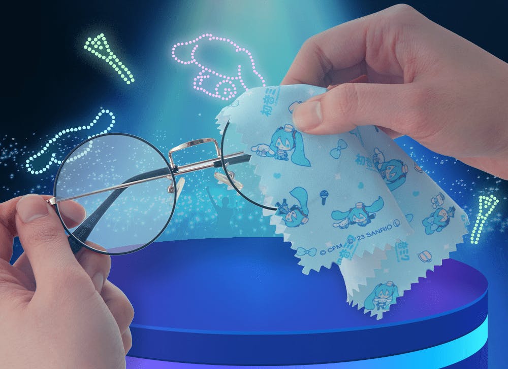 A picture of hands using a Hatsune Miku and Cinnamoroll microfiber cloth to clean glasses in front of a dark background with colorful neon lights.
