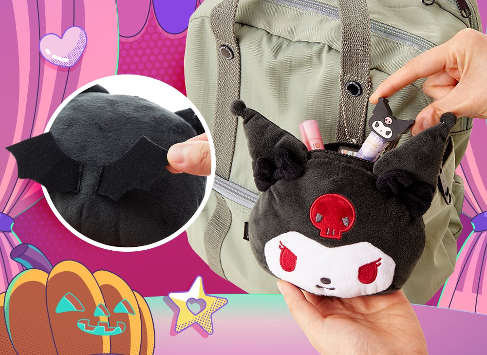 A hand holding the Kuromi Face Pouch and placing a coin inside the pouch
