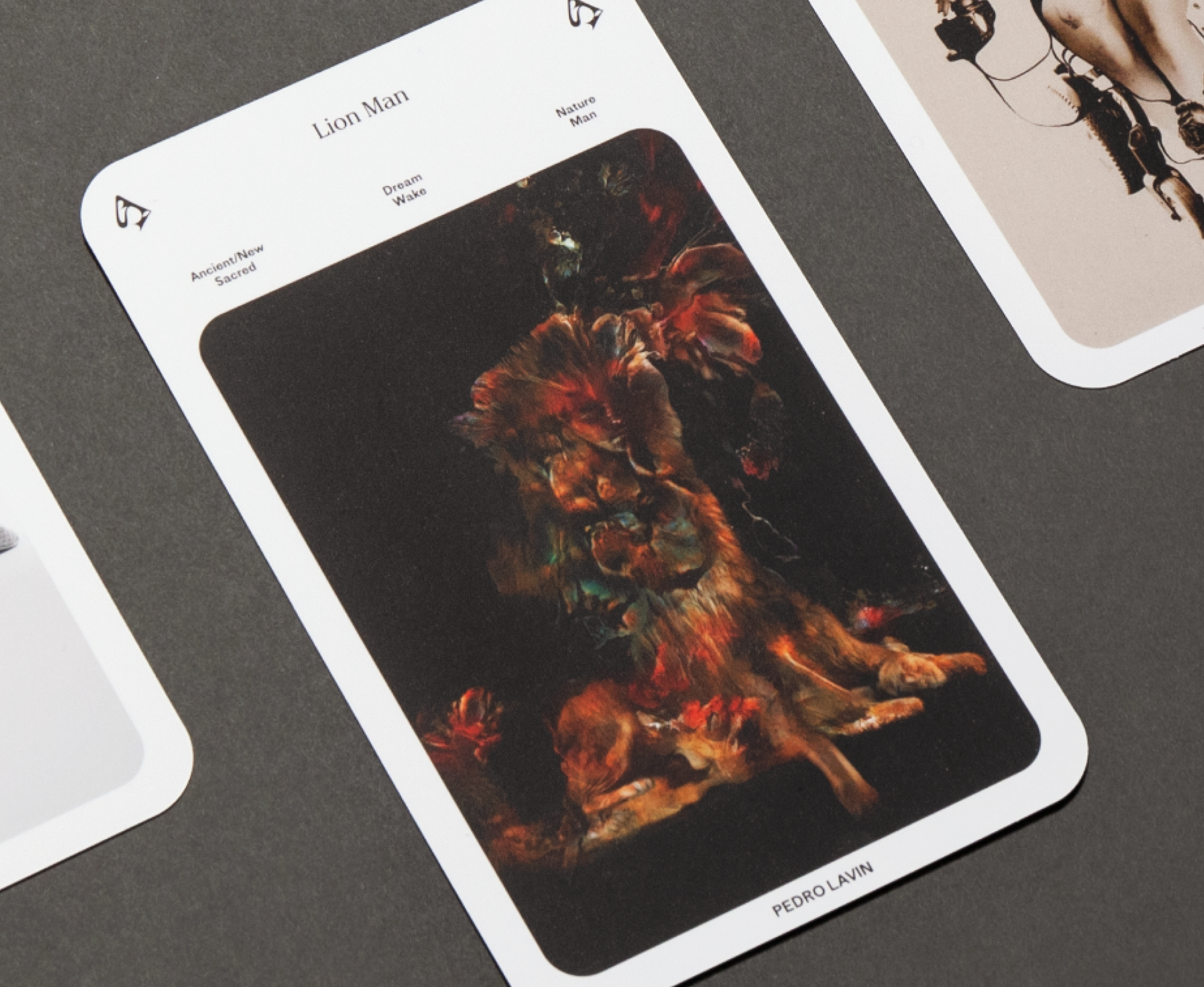 Photo of a single card from the Sleepwalking deck. The title is Lion Man and shows a photo manipulation in warm golden and reds against a black background.