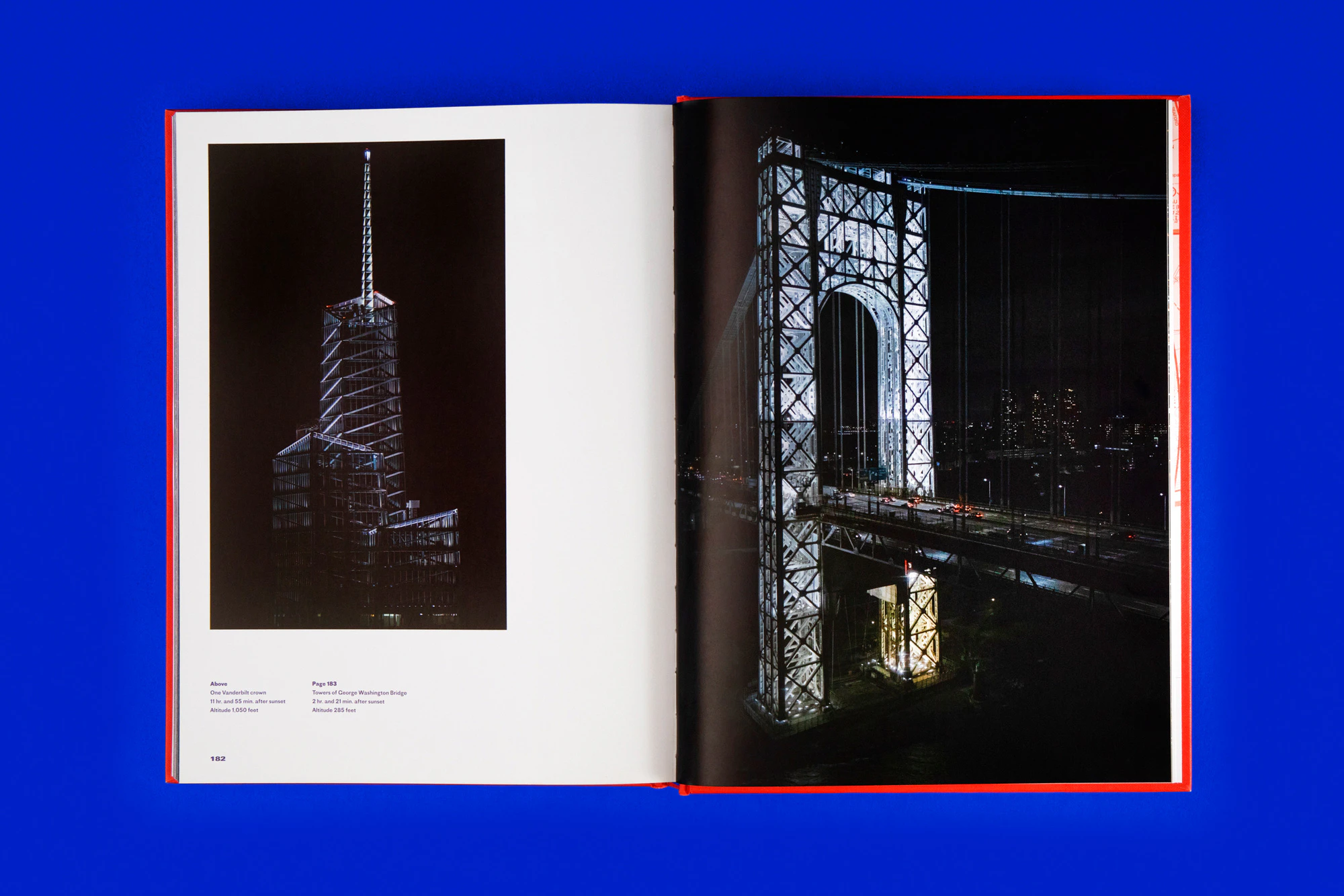 Overhead photo showing the book open to a double spread of a bridge and a high-rise building. The colors of the two photos are mostly black with light making part of them brighter. The book is lying on a cobalt blue seamless.