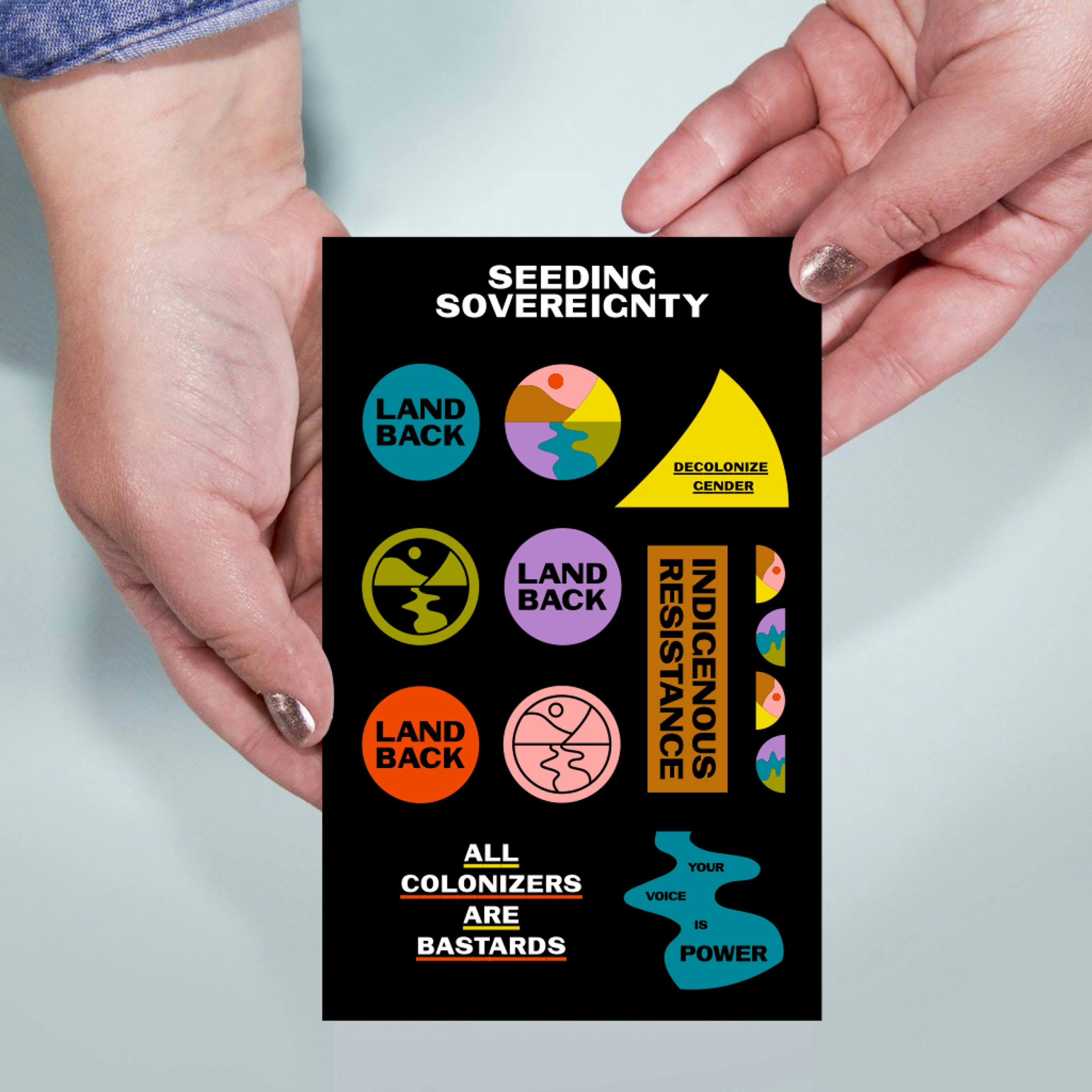 Image shows hands holding a sticker sheet with stickers that read LAND BACK, DECOLONIZE GENDER, INDIGENOUS RESISTANCE, ALL COLONIZERS ARE BASTARDS, and YOUR VOICE IS POWER. 