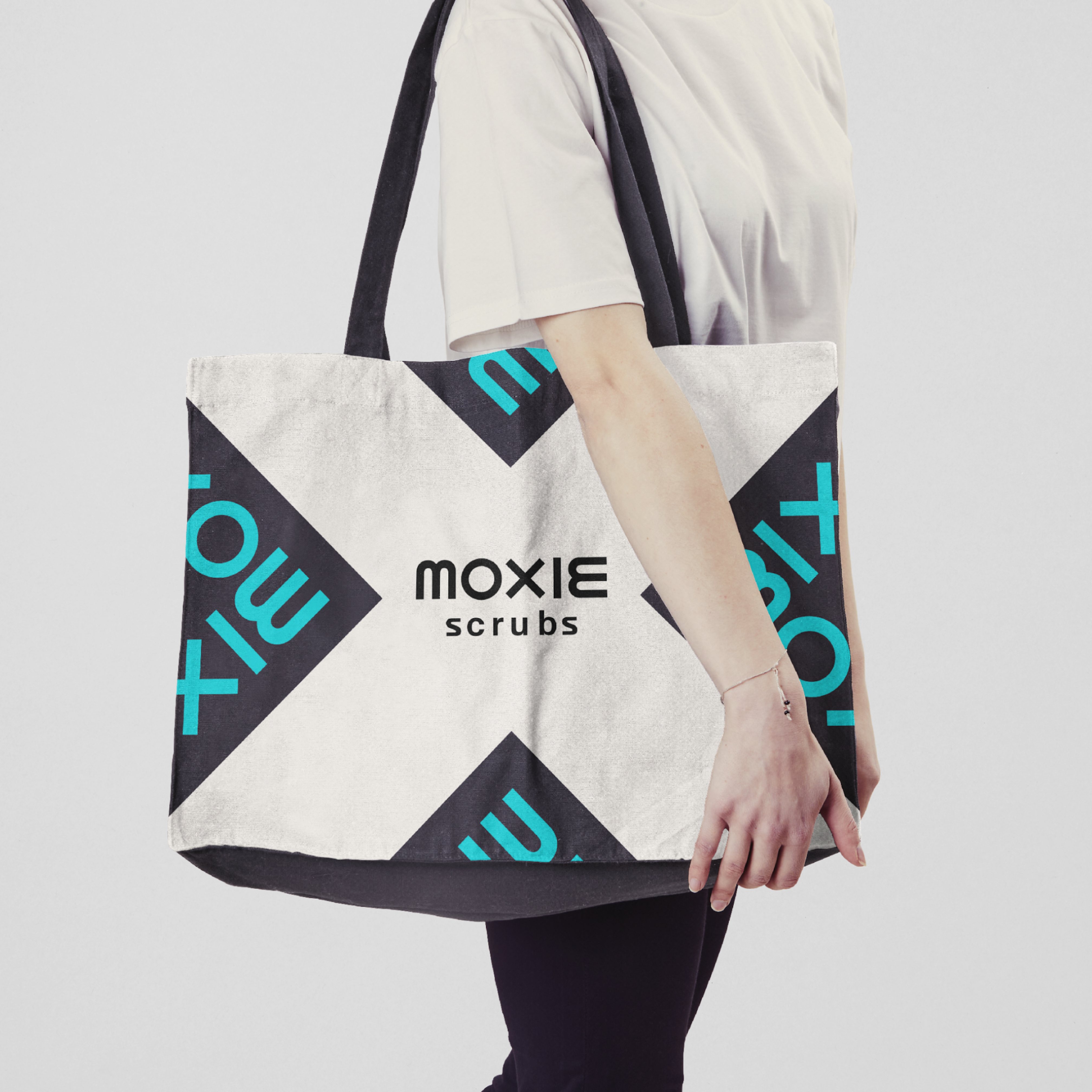 Moxie Tote bag with blue wordmark in square and wordmark in the middle in dark gray.