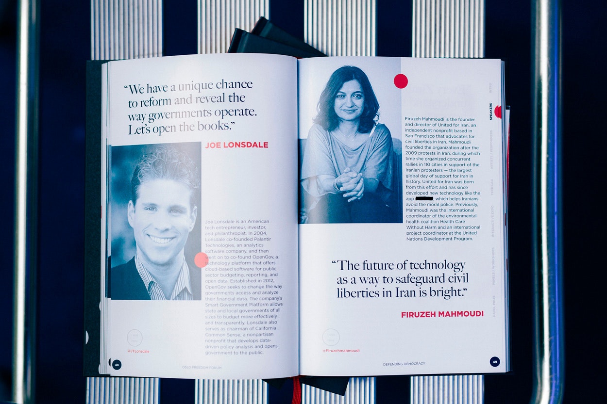 Image shows an open publication on a striped background. There are blue-toned portraits and red polka dots on the pages.