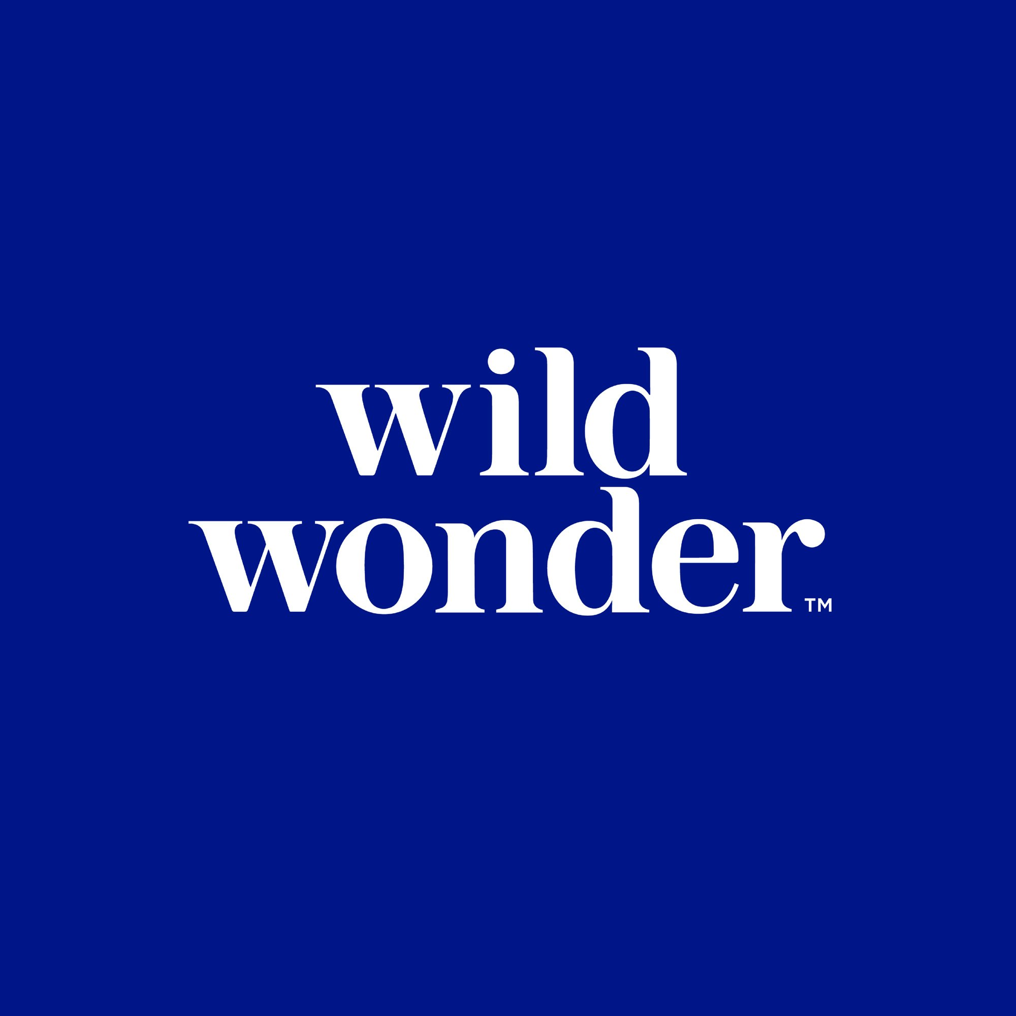 wild wonder logo in white on a sapphire blue background