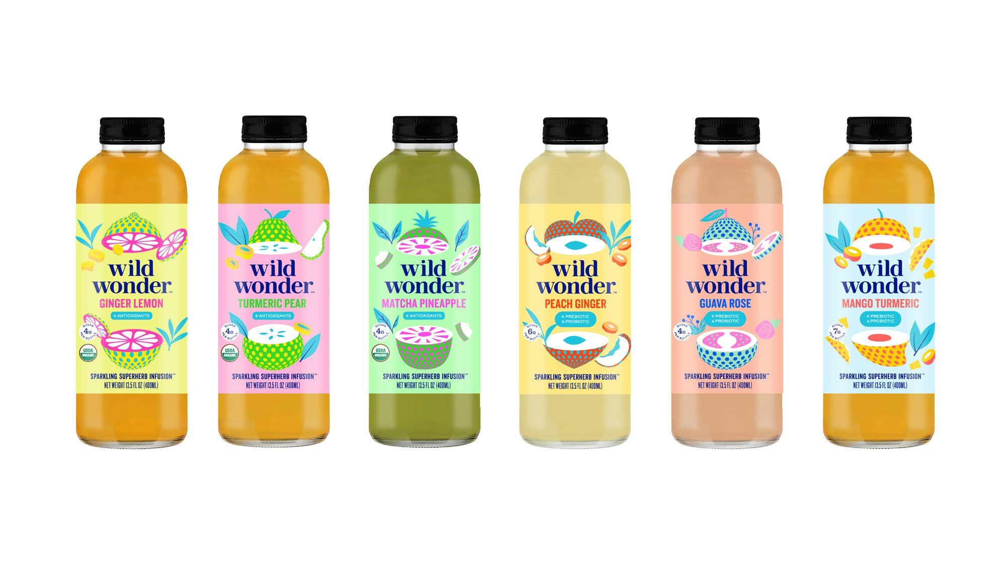 All of wild wonder's bottles next to each other. There are six in total and the flavors are ginger lemon, turmeric pear, matcha pineapple, peach ginger, guava rose, mango turmeric.
