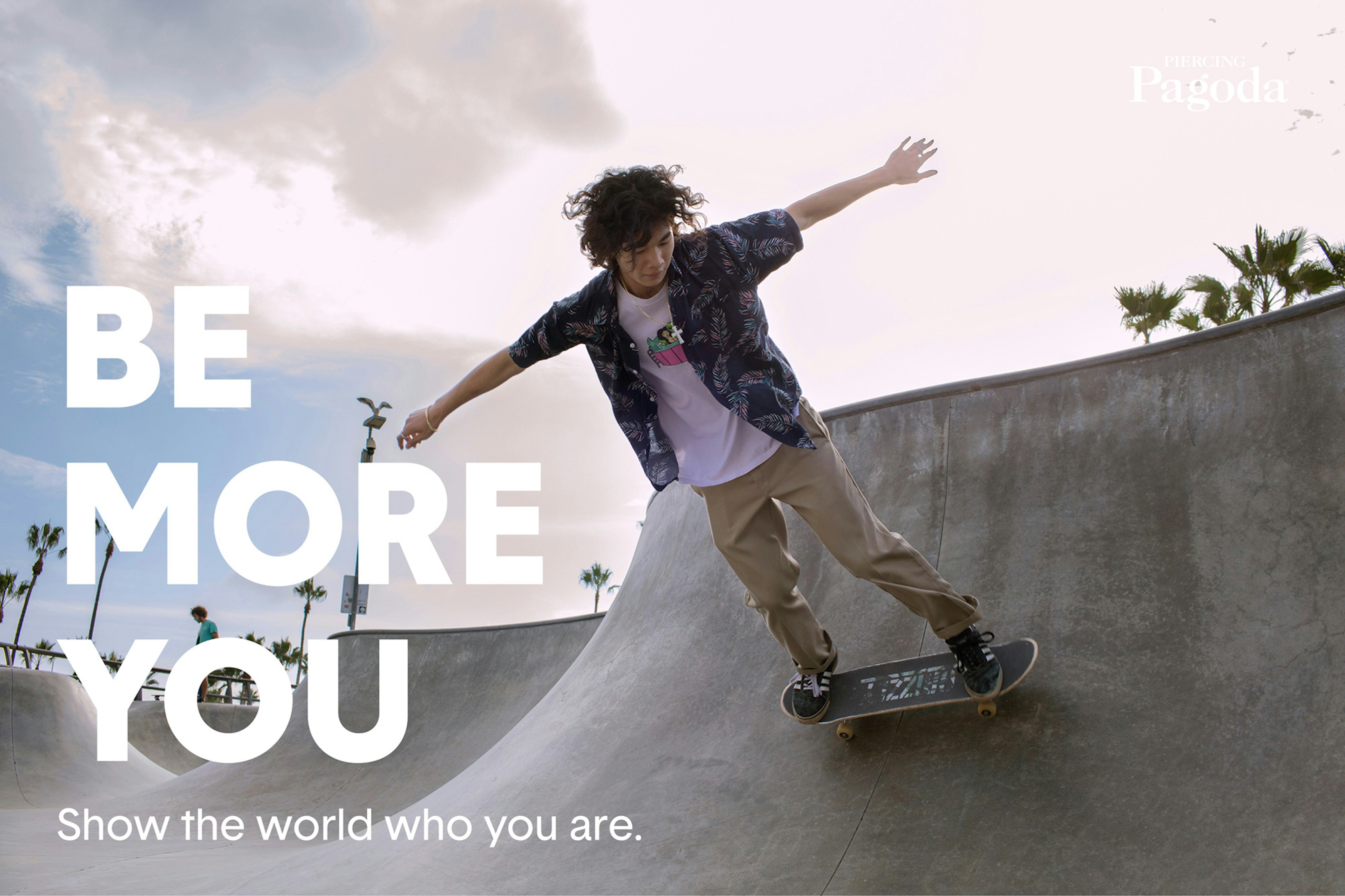 Image showing person skating in a skate park in Los Angeles. They are holding their arms out to the sides for balance and in the background there are palm trees.