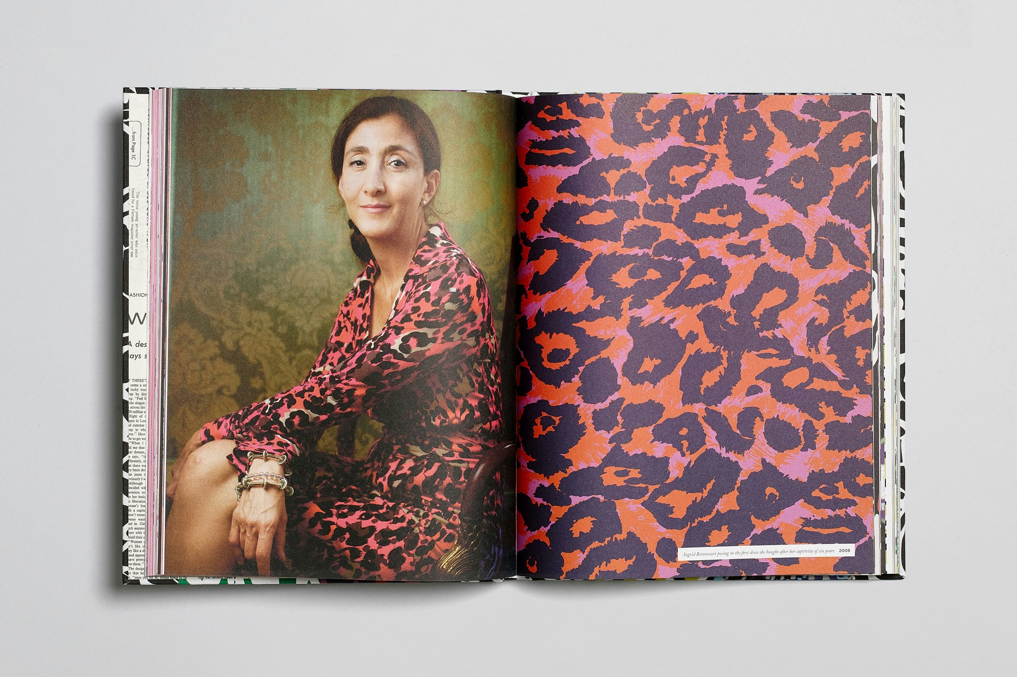 Image showing the DVF book open to a spread with a person on the left side wearing a wrap dress in a DVF print and on the other page the print is shown oversized.