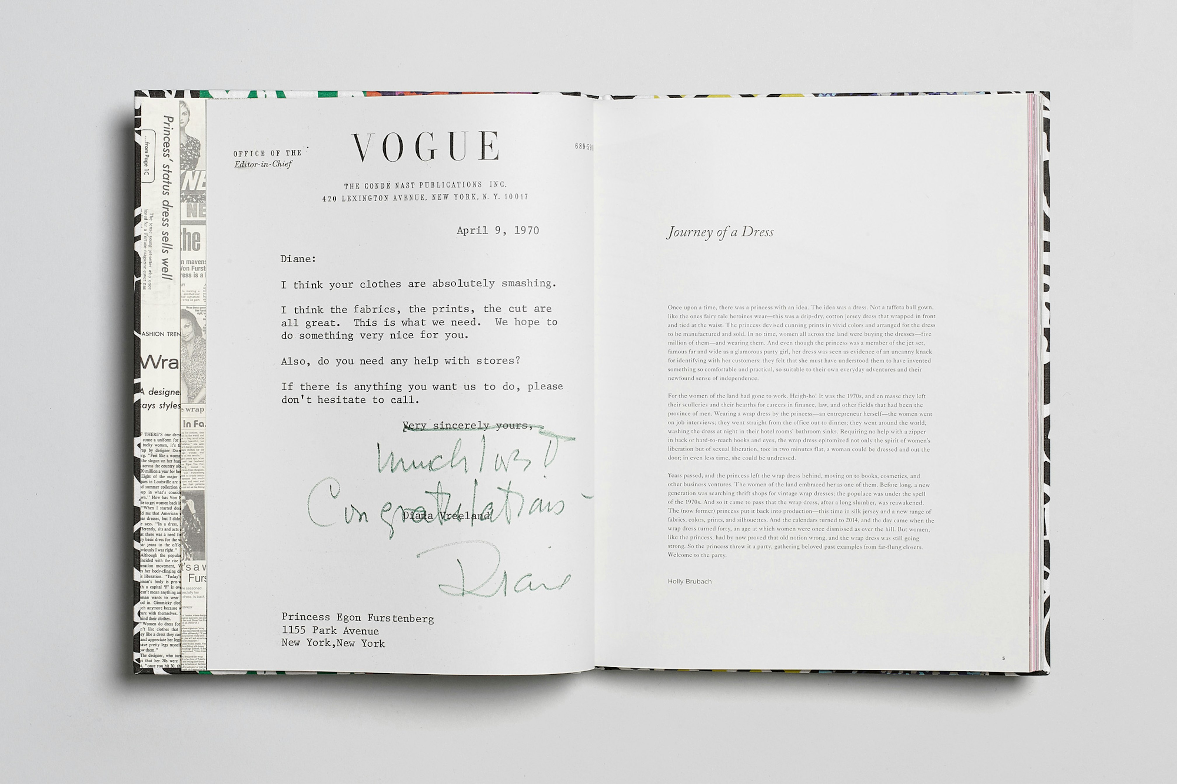 Image showing the book open on a gray seamless. On the pages is shown the letter Furstenberg received from Vogue.