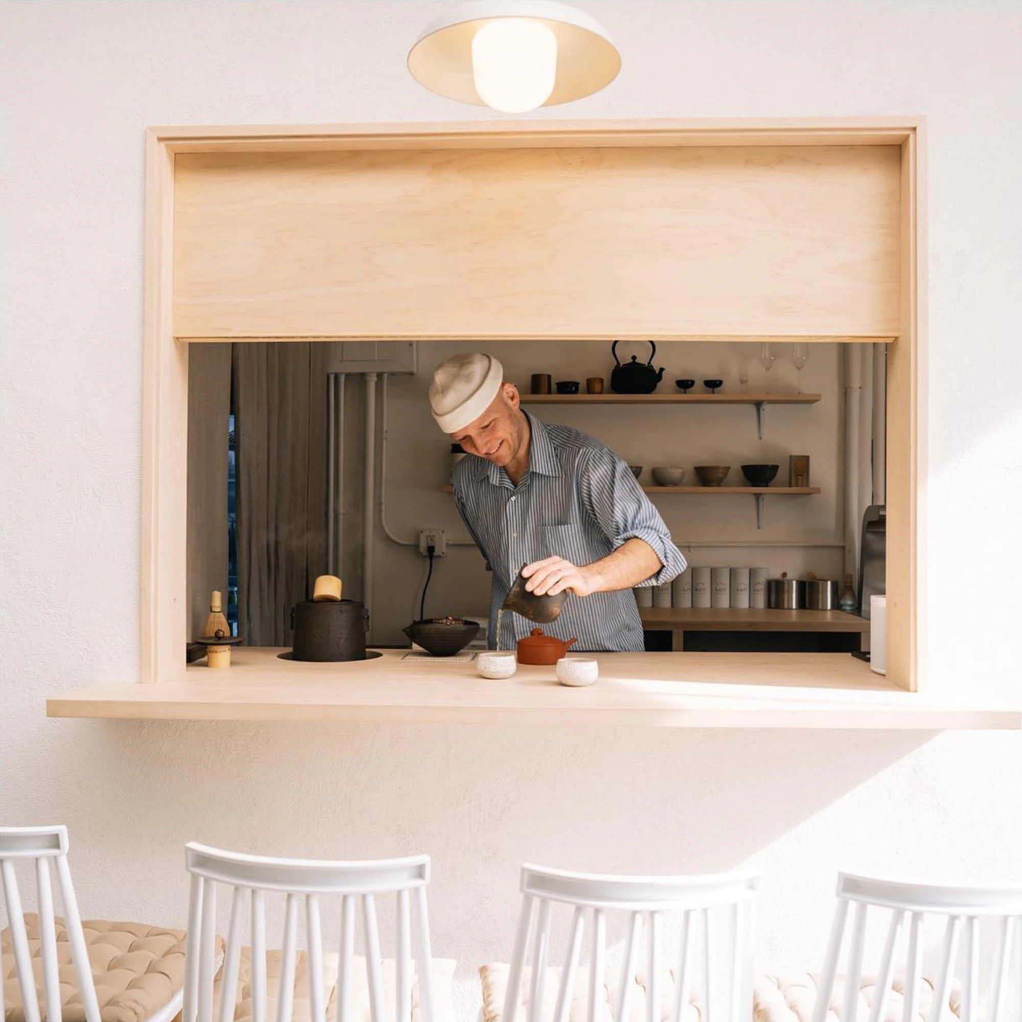 Image showing the Kettl cafe with a person pouring a matcha into a ceramic cup.