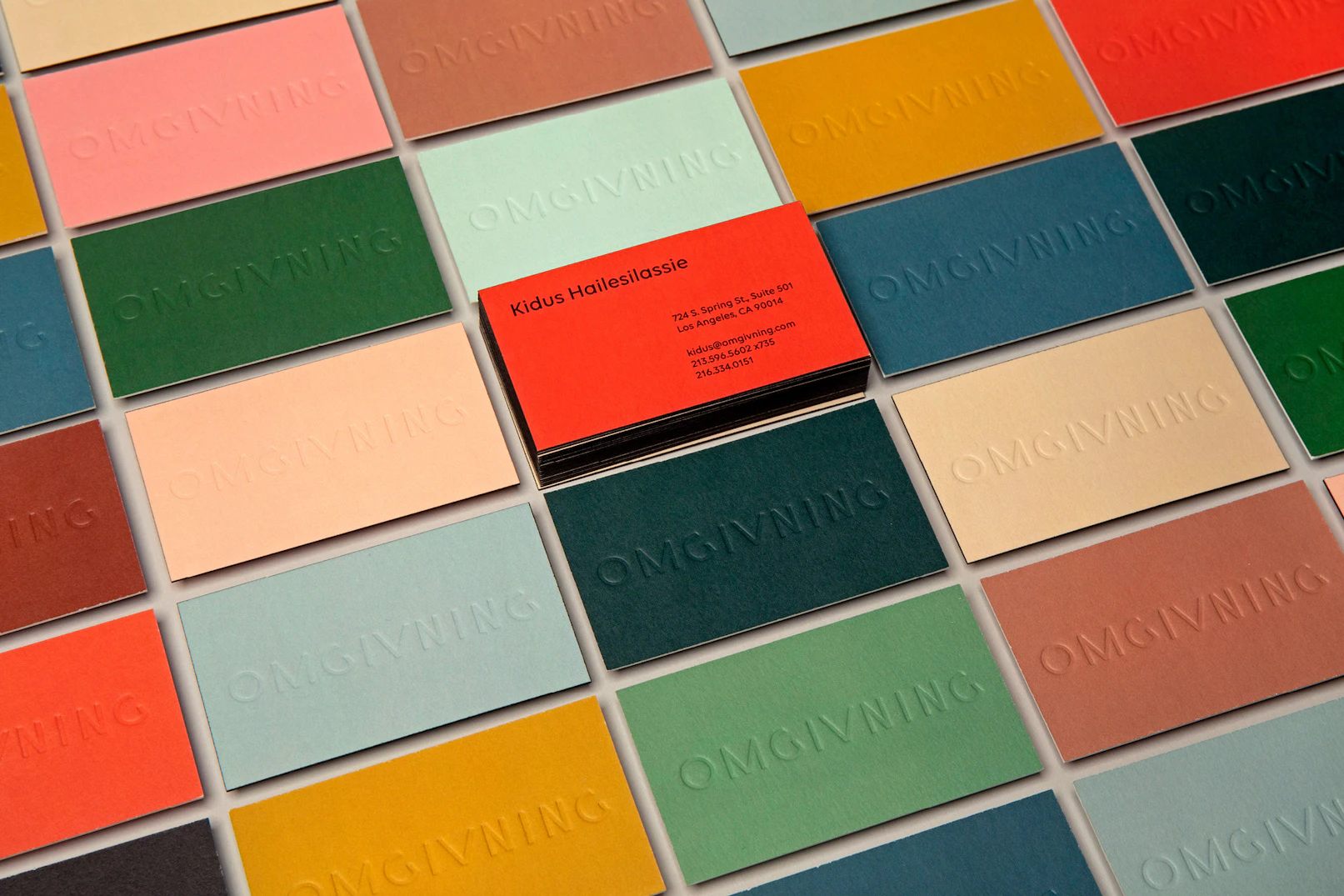 Photo showing the brand business cards in all the brand colors.