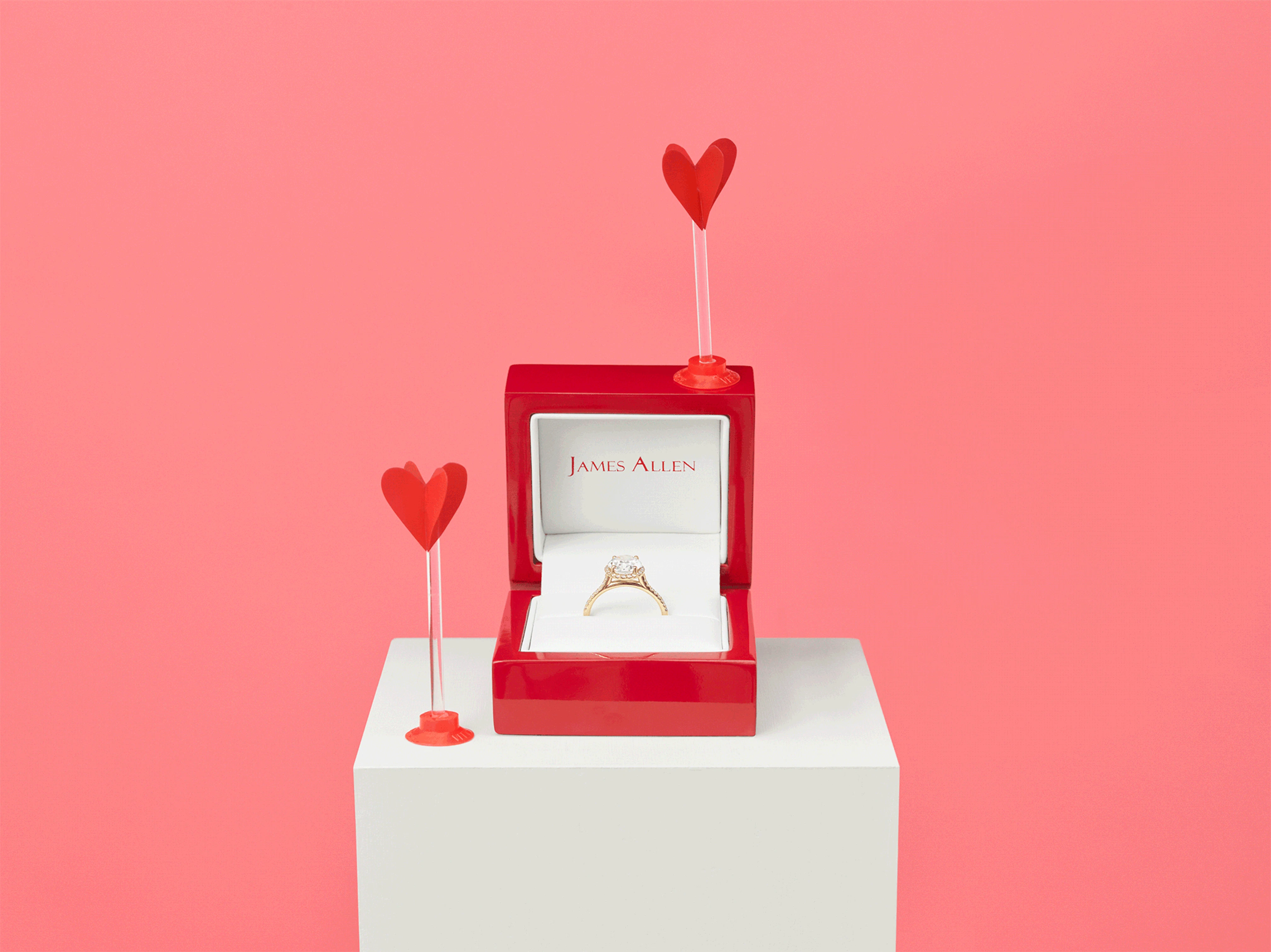 Animation showing red mini heart arrows shooting towards an open ring box with an engagement ring inside.