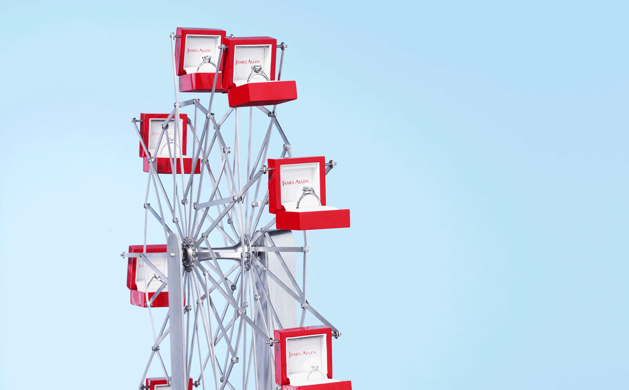 Ferris wheel made from open ring boxes with engagement rings inside.