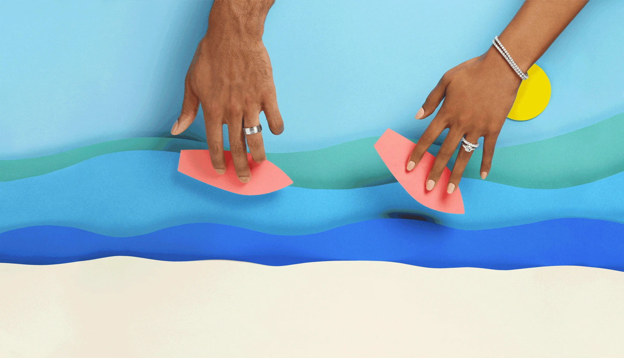 Animation showing two hands surfing on mini paper surfboards on paper waves.