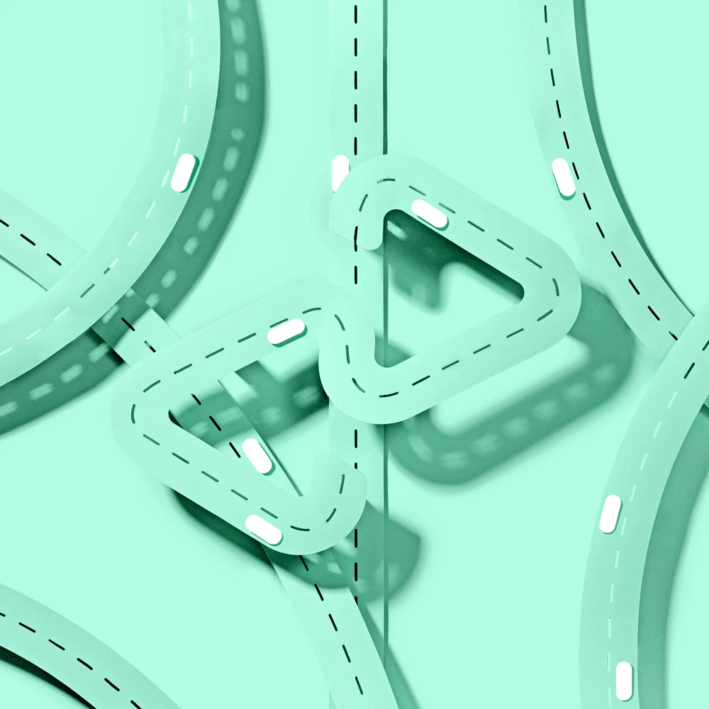 Animation showing miniature mint colored high ways with little white pill shaped cars driving around on the streets. The center of the streets is the Afterpay logo.