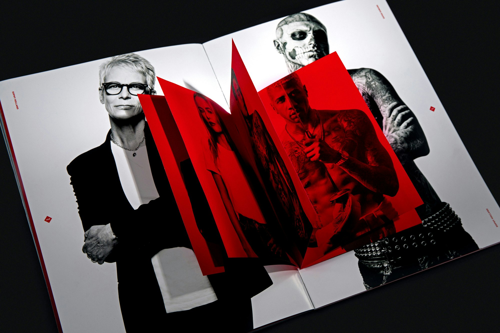 Image shows a close-up of a spread of black-and-white images with a small all-red booklet within that spread.