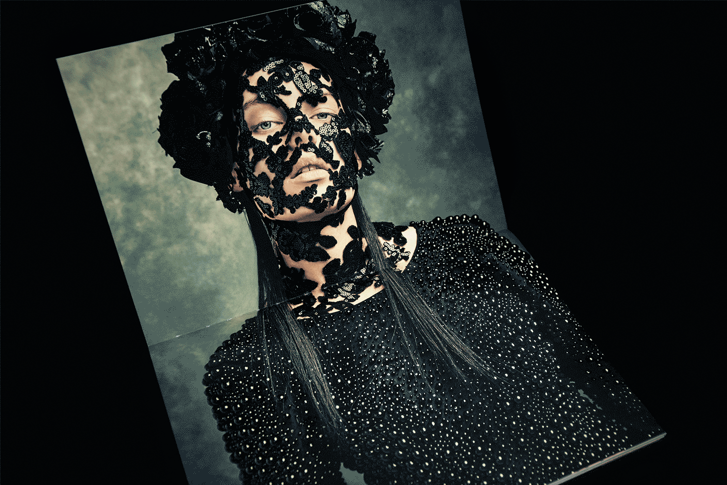 Animation shows a spread with spot gloss glistening in a moving light.