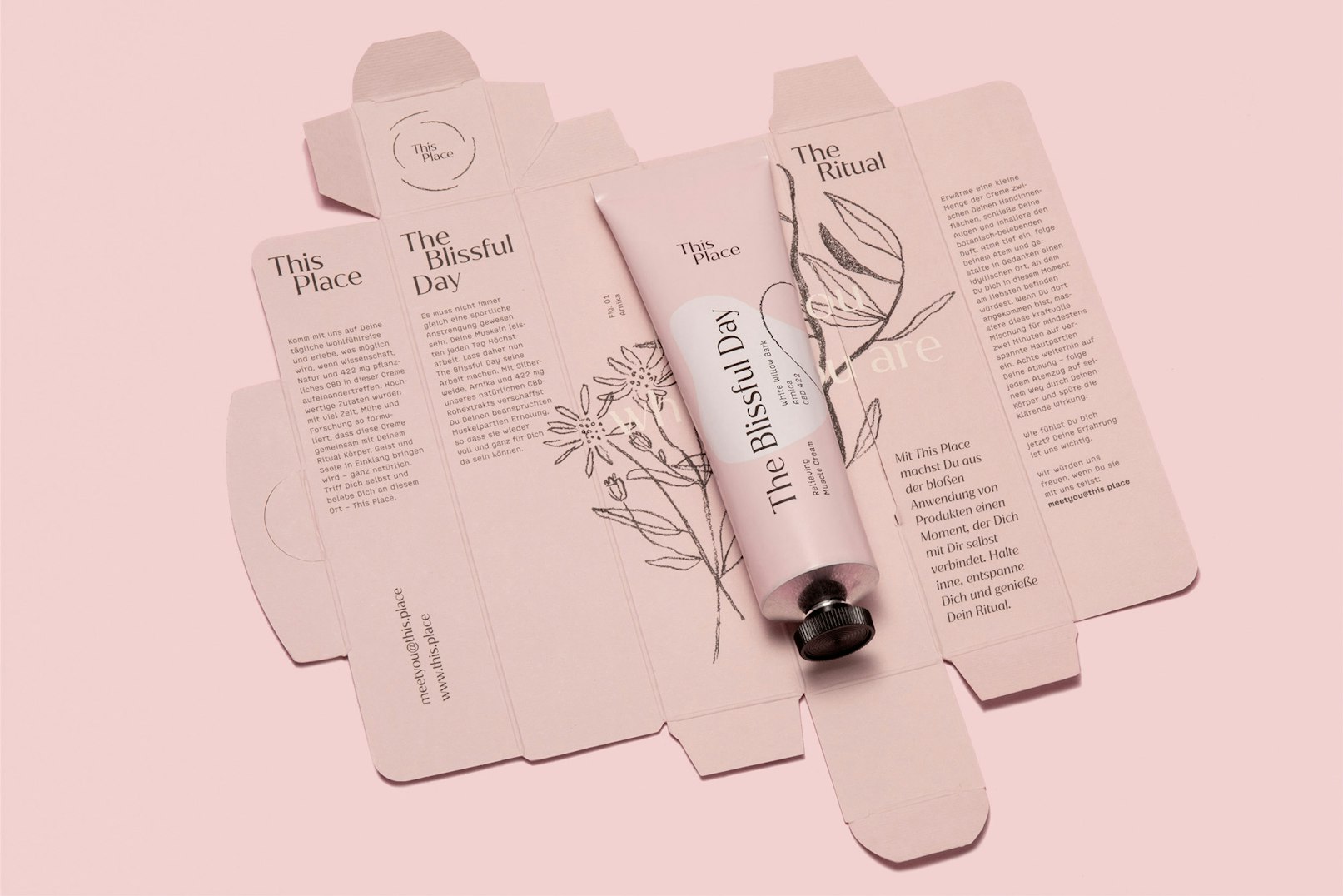 Image showing the pink tube lying on top of the open, flattened packaging.