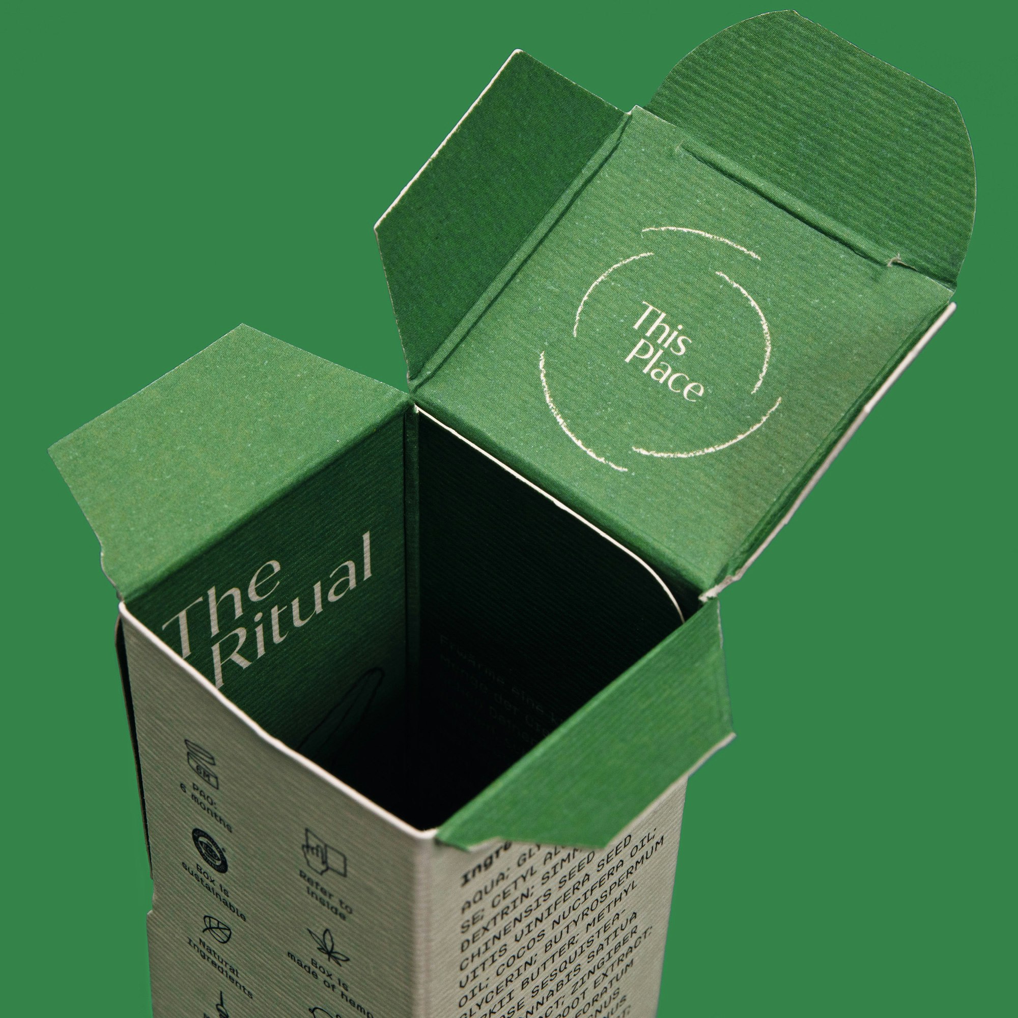 Photo showing a closeup of the green packaging with the top open revealing the logo printed inside.