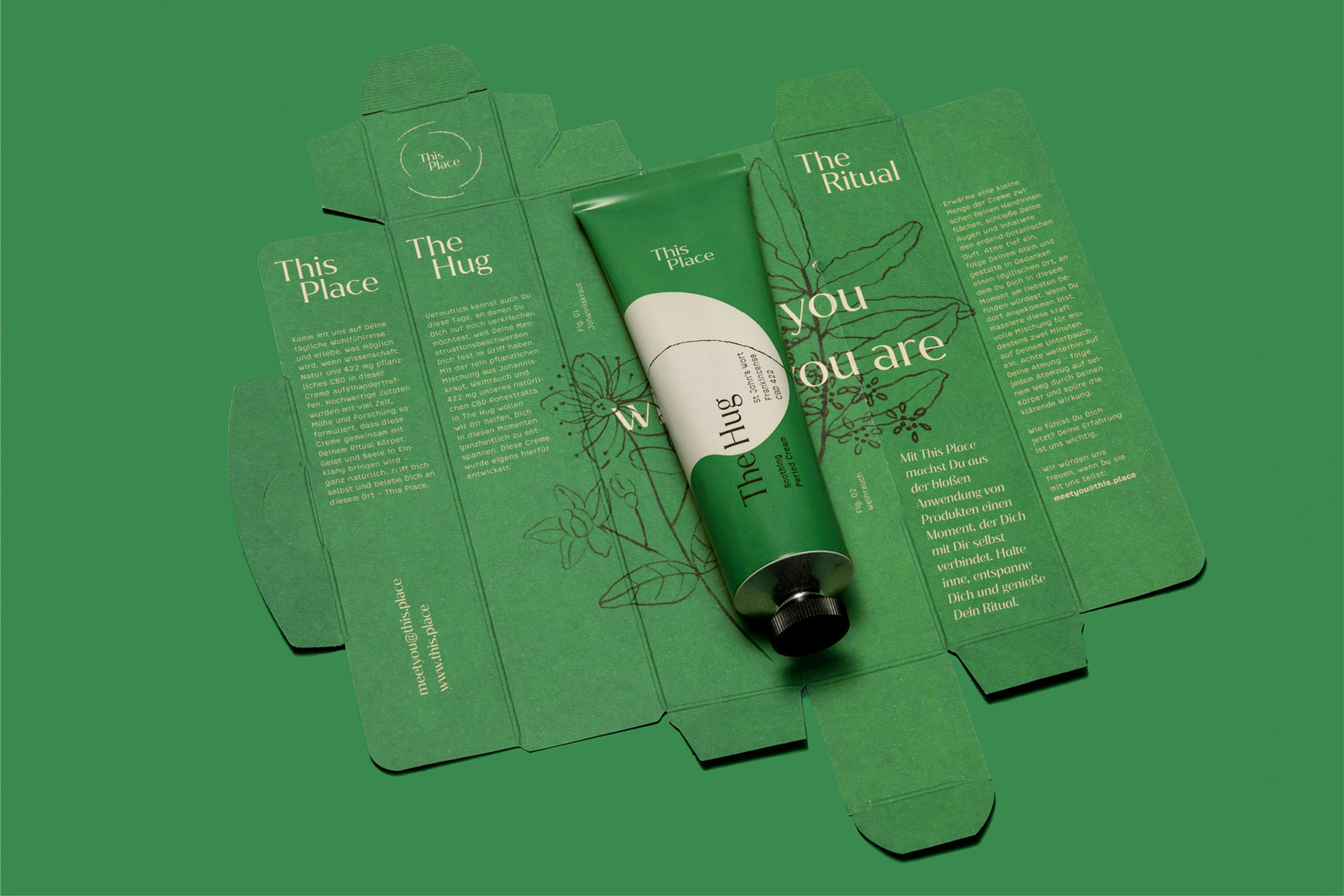 Image showing the green tube lying on top of the open, flattened packaging.