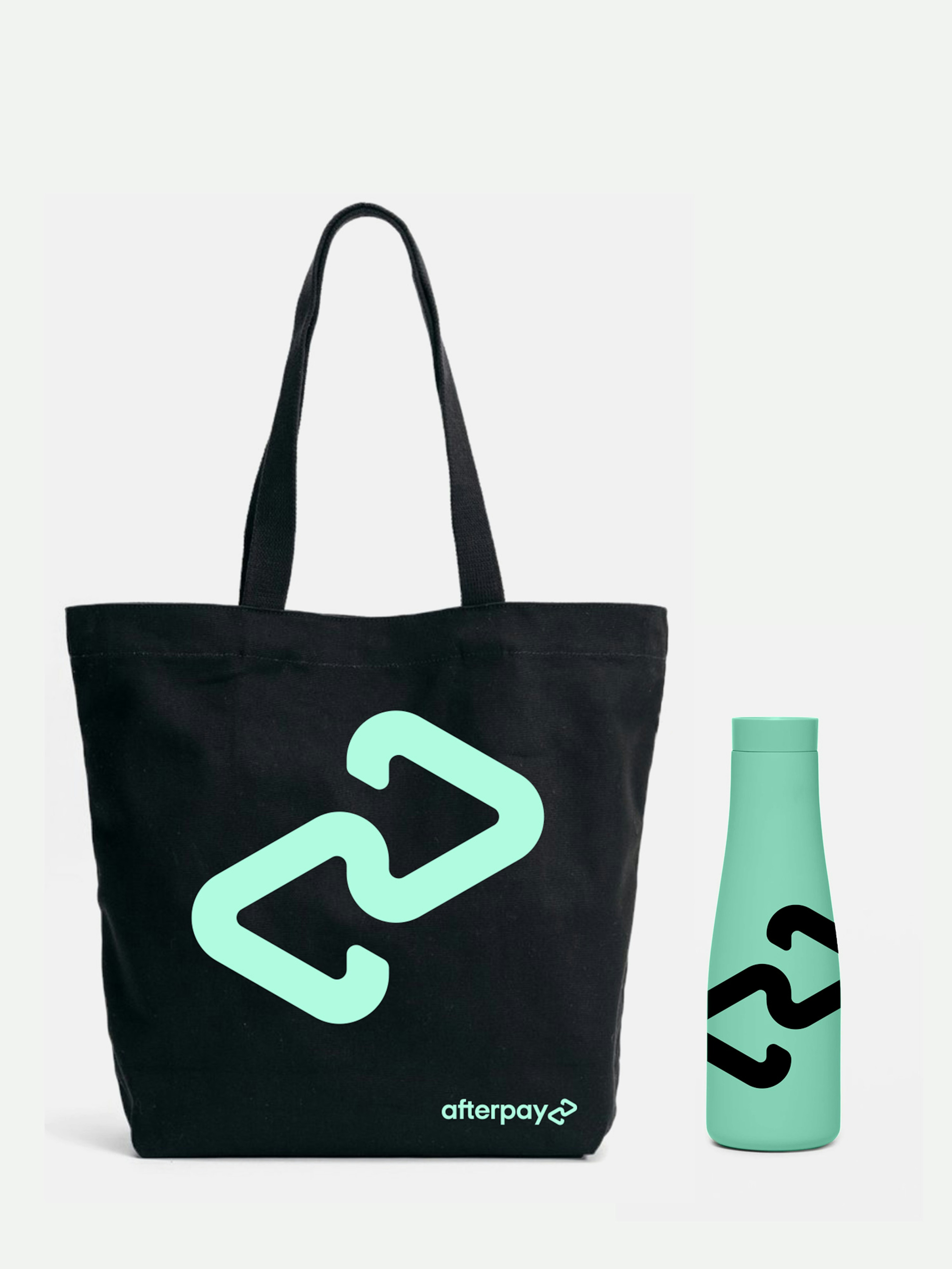 Image showing mockups of a black tote bag with the mint Afterpay logo on it and mint water bottle with the black Afterpay logo printed on it.