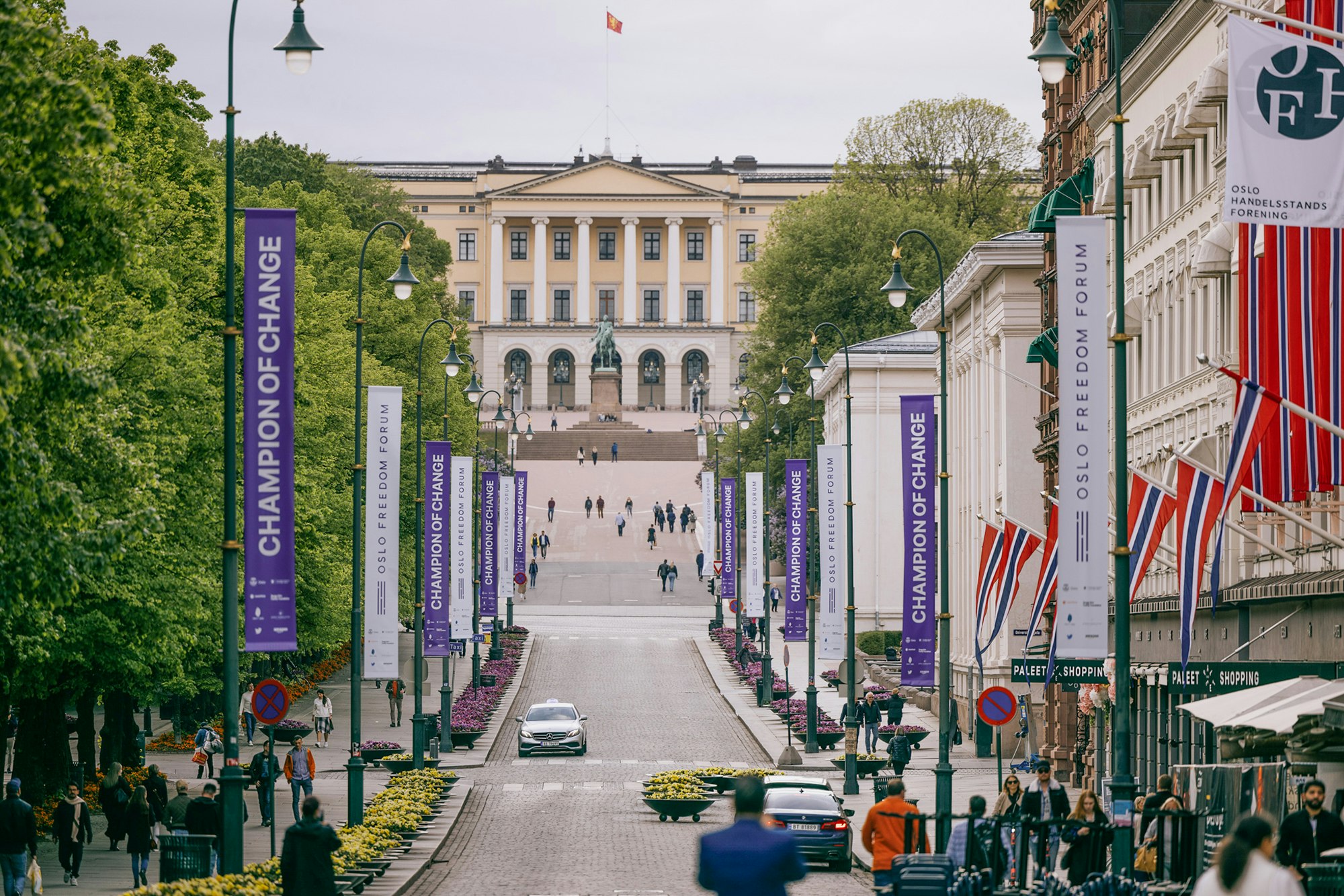 Banners attached to the light polls, are displaying along Oslo street. There're two design alternating each other. One is Champion of Change in white with the sponsor logos at the bottom on a purple background. One is Oslo Freedom Forum logo in purple with the sponsor logos at the bottom on a white background.
