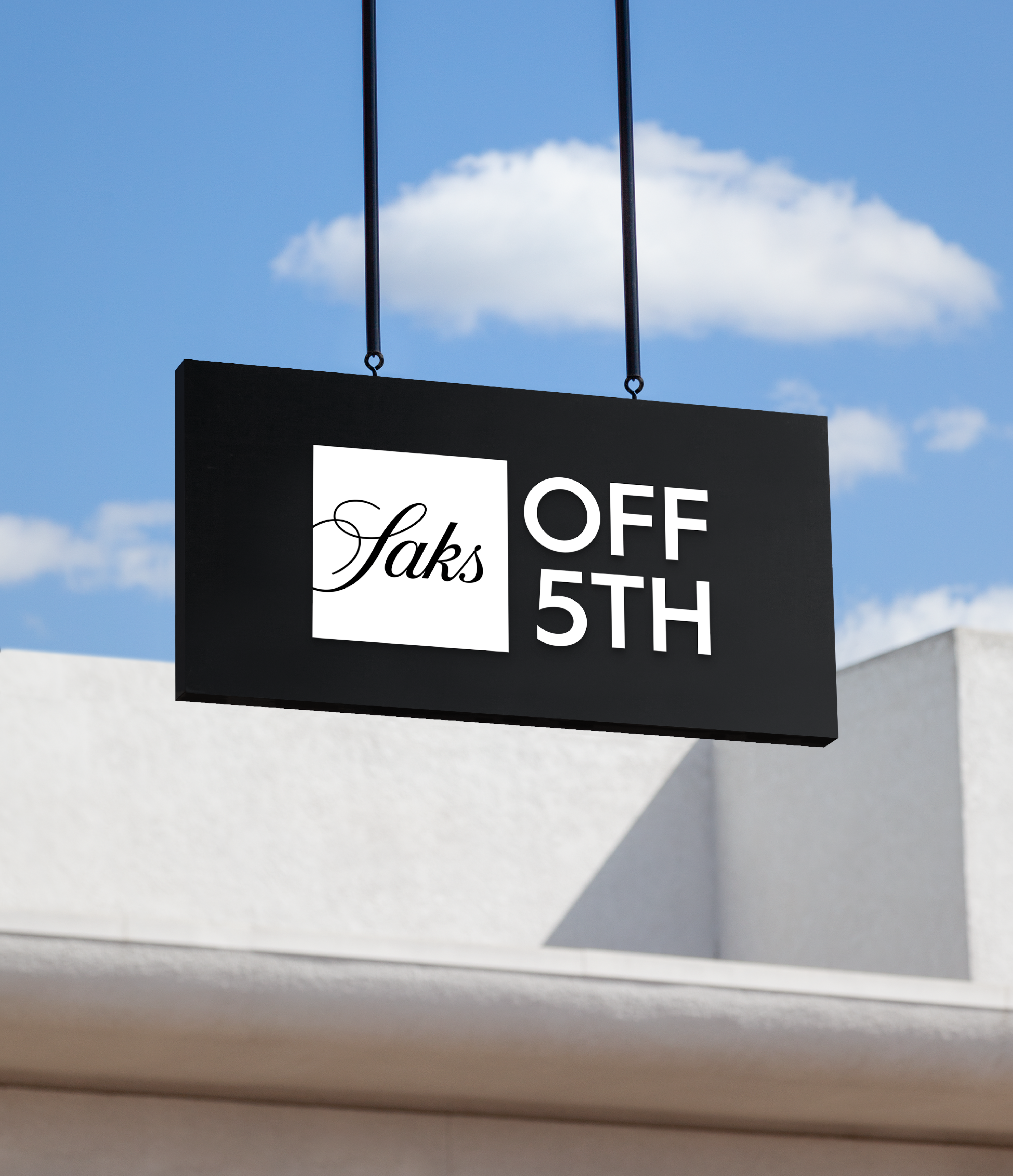 SO5 Signage with the logo in white on a black background. Behind the signage, there're white building and blue sky with clouds.