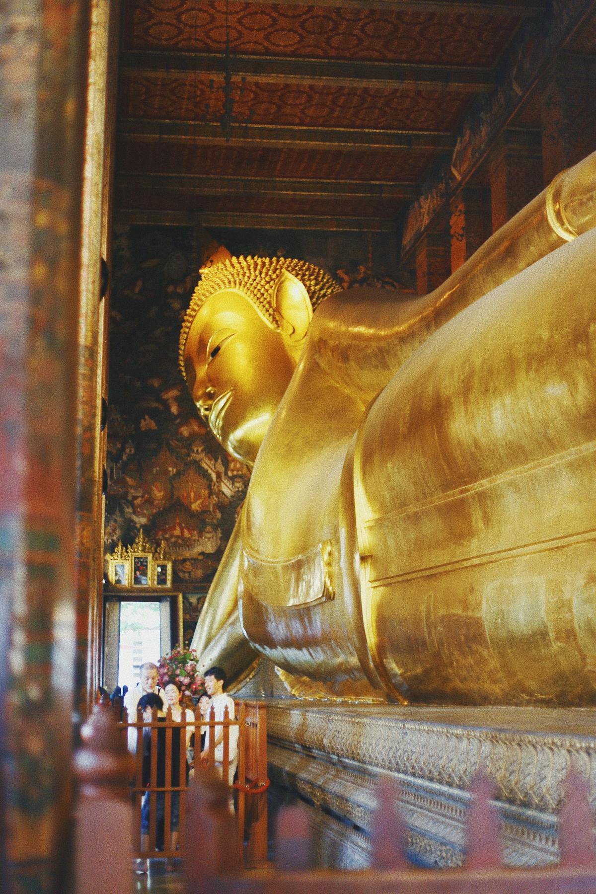 Lying Buddha in gold 45 m long 3/4 view -Photo by Taylor Simpson on Unsplash