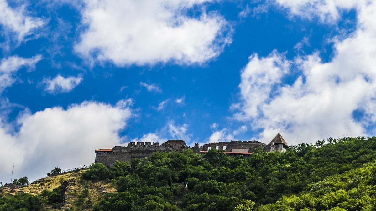 Photo of a castle on top of a hill