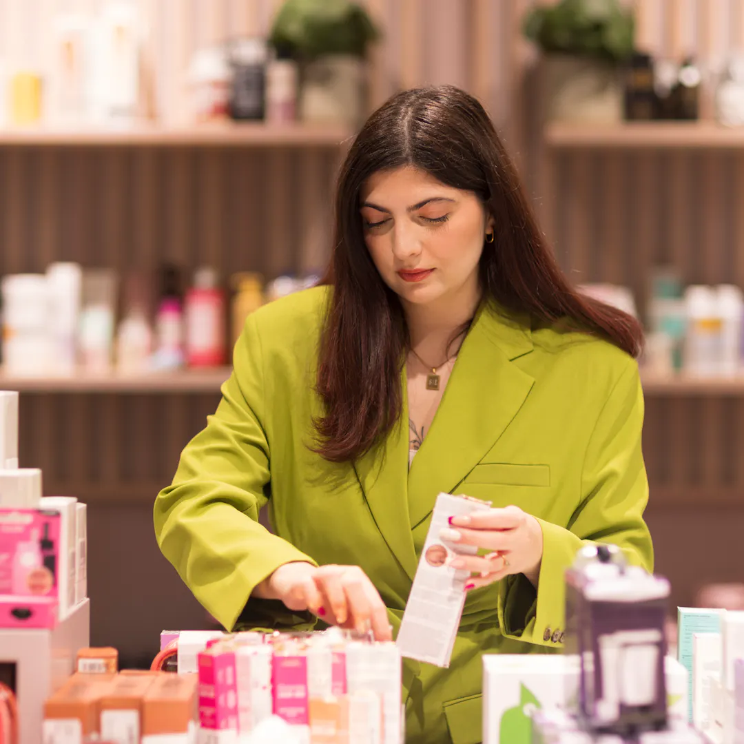 Outlet by Zalando colleague is working in the beauty section in the store.