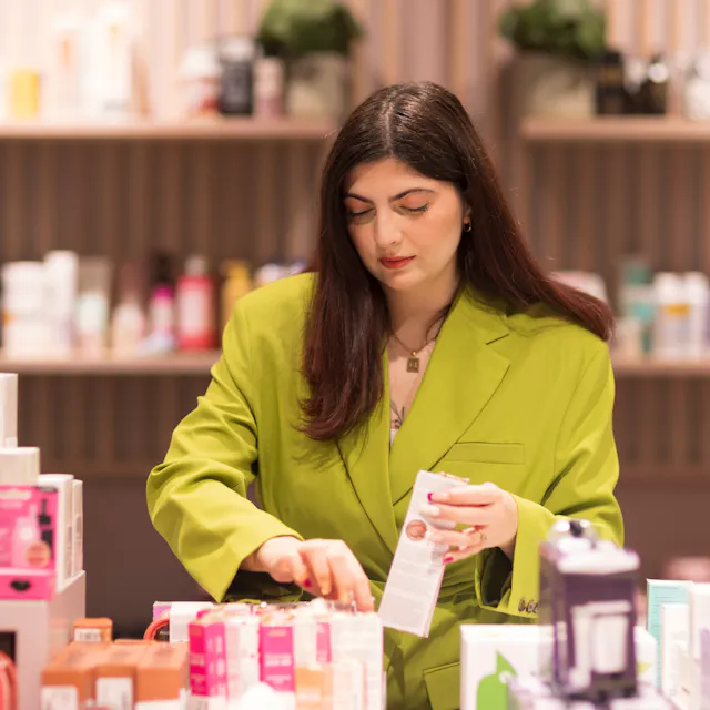 Outlet by Zalando colleague is working in the beauty section in the store.
