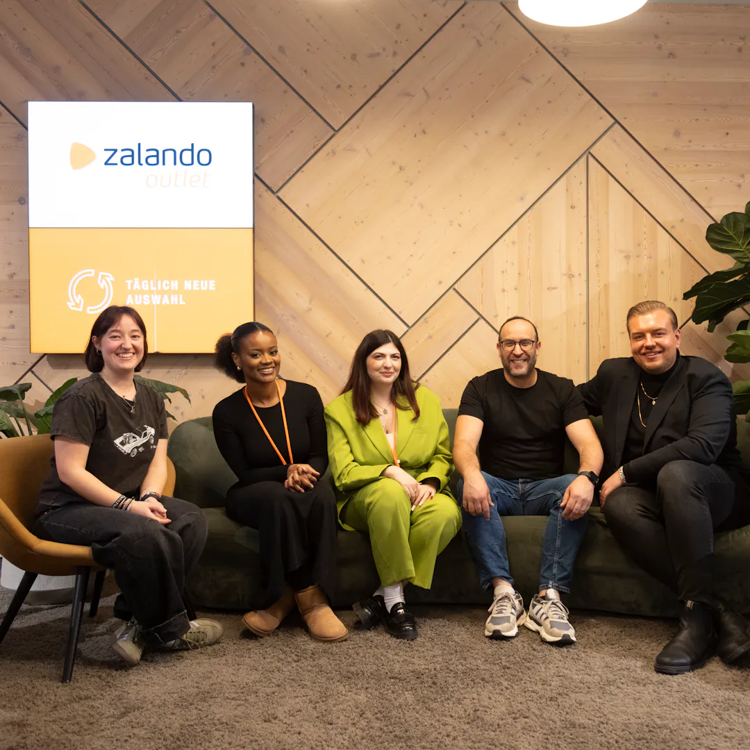 Outlet by Zalando team is together in the lounge area.