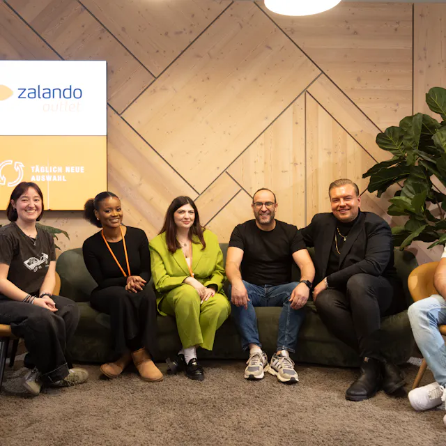 Outlet by Zalando team is together in the lounge area.