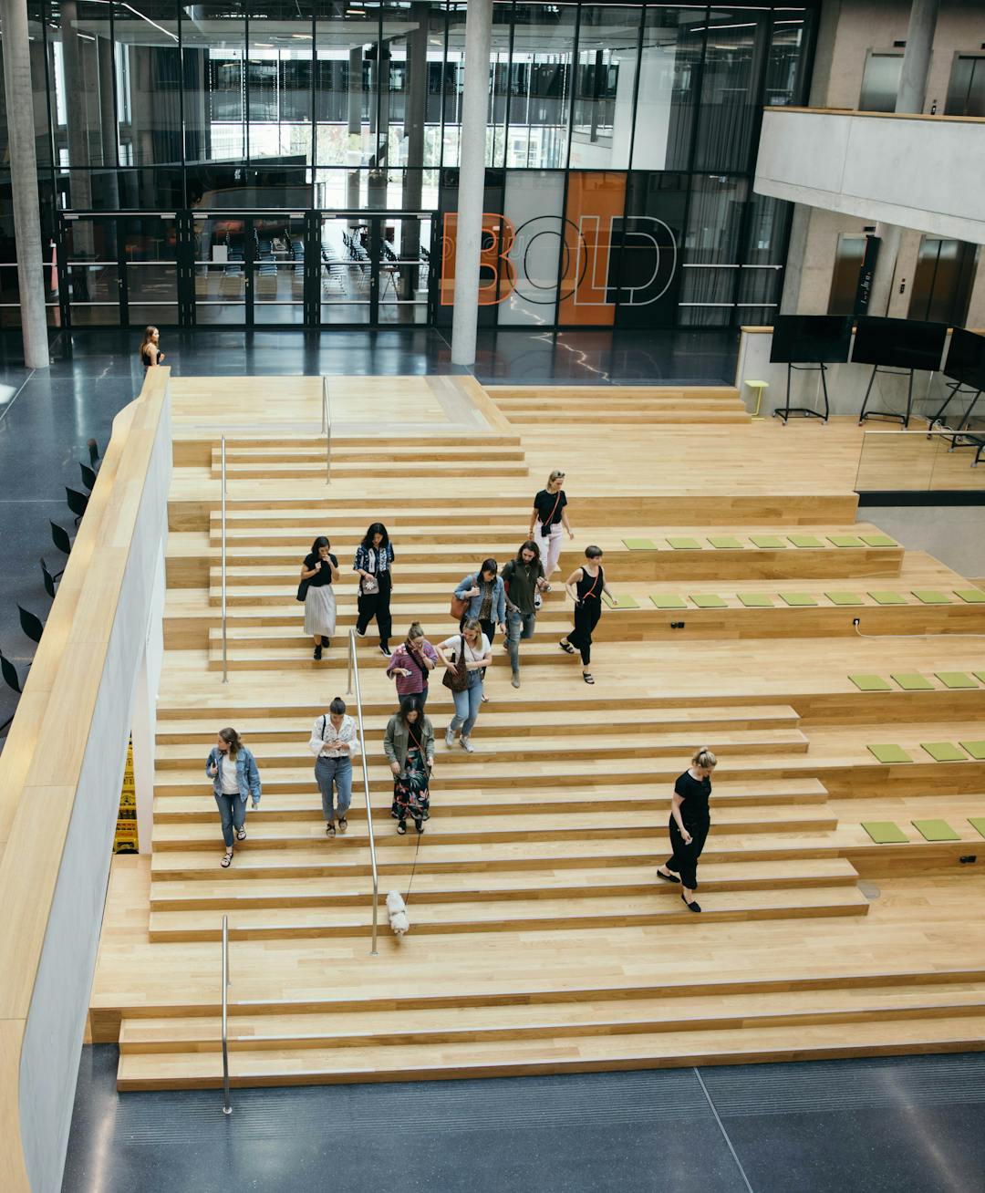 Zalando employee's and a "Zalandog" walking down the BHQ-X atrium stairs