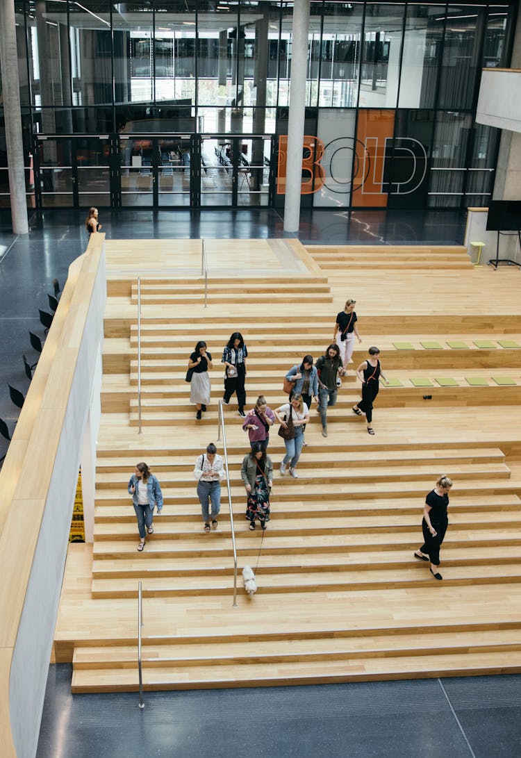 Zalando employee's and a "Zalandog" walking down the BHQ-X atrium stairs