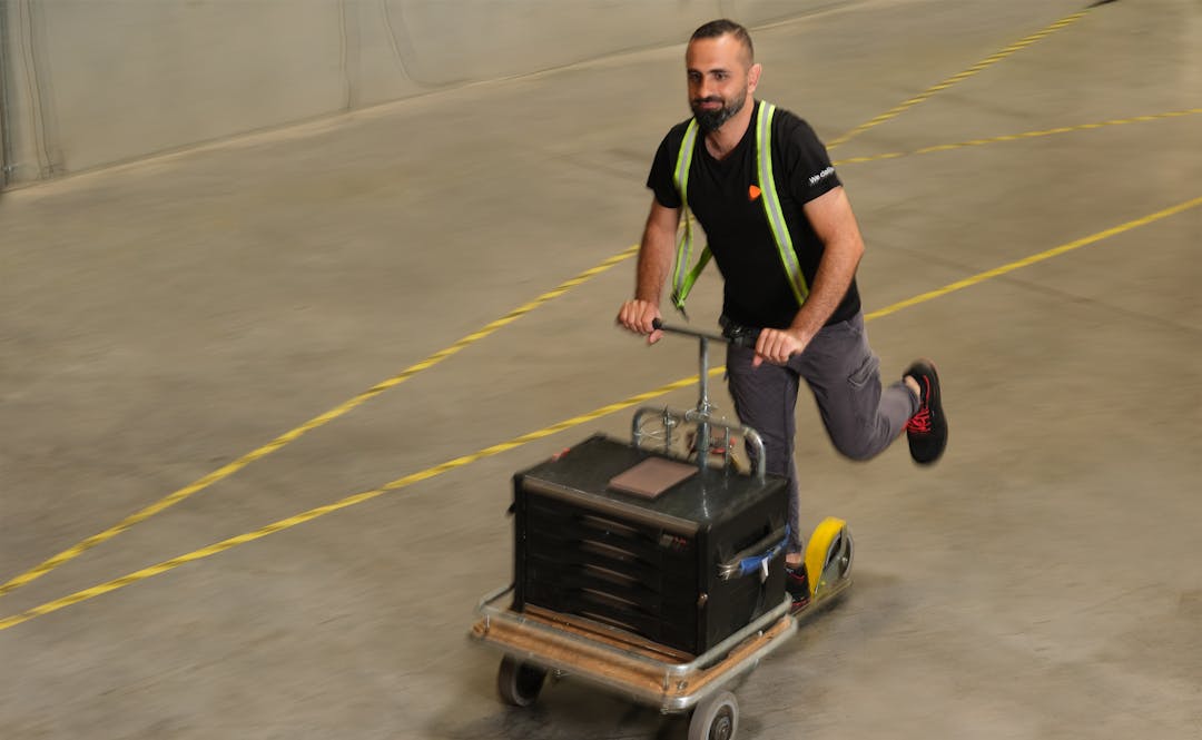 A person driving a cart at the warehouse