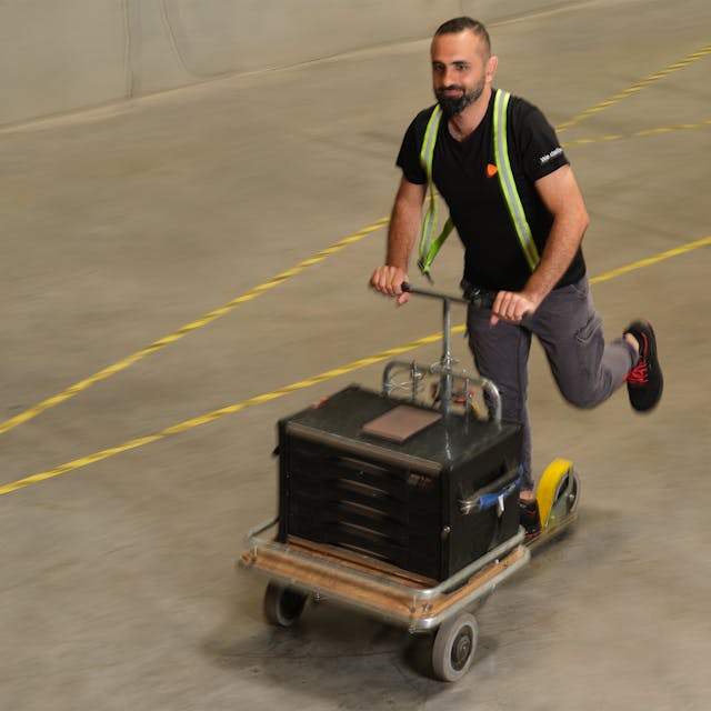 A person driving a cart at the warehouse