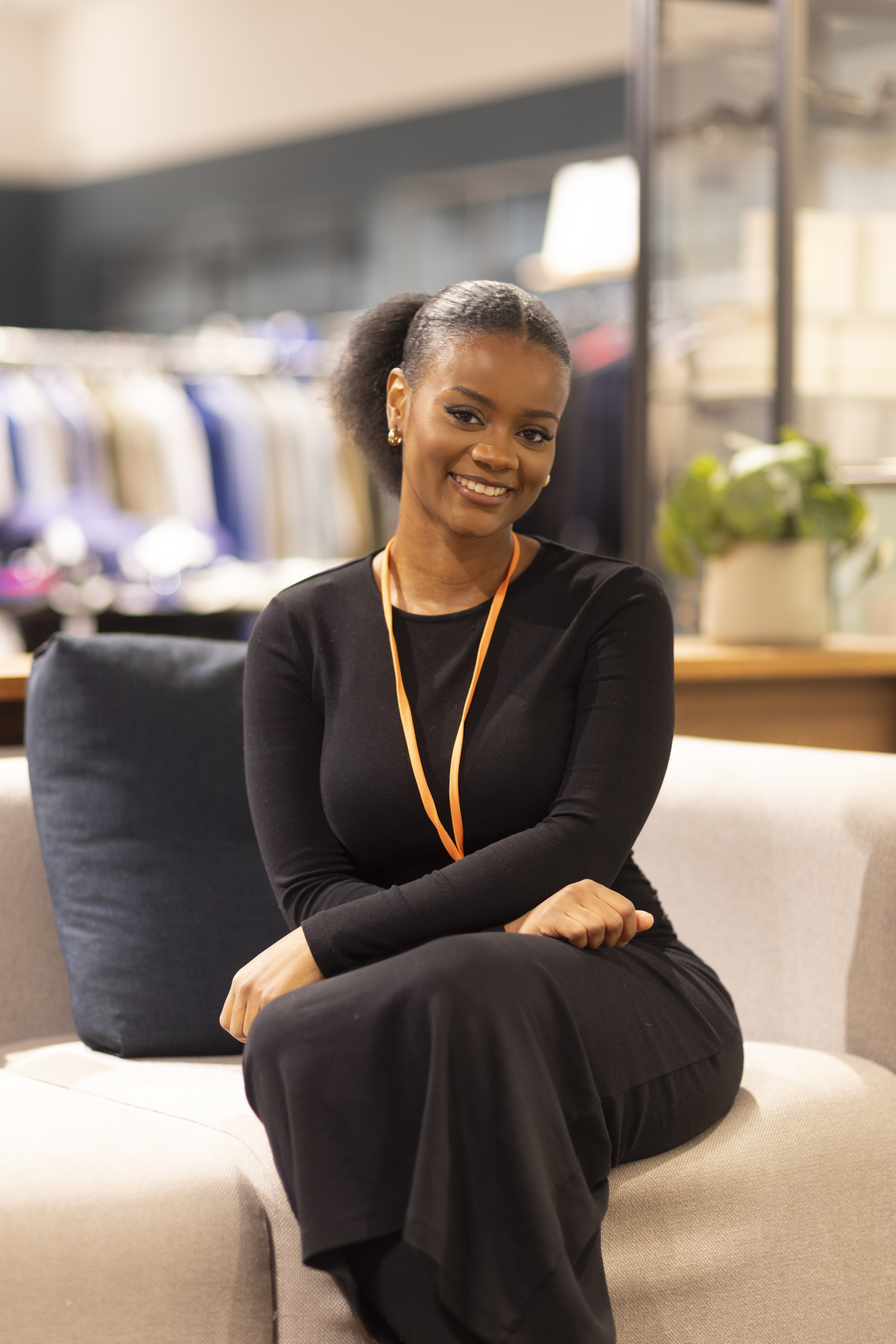 Outlet by Zalando colleague seats on the couch in the store.