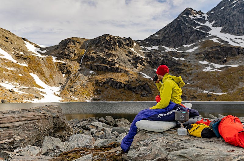 Man sitting next to mountains