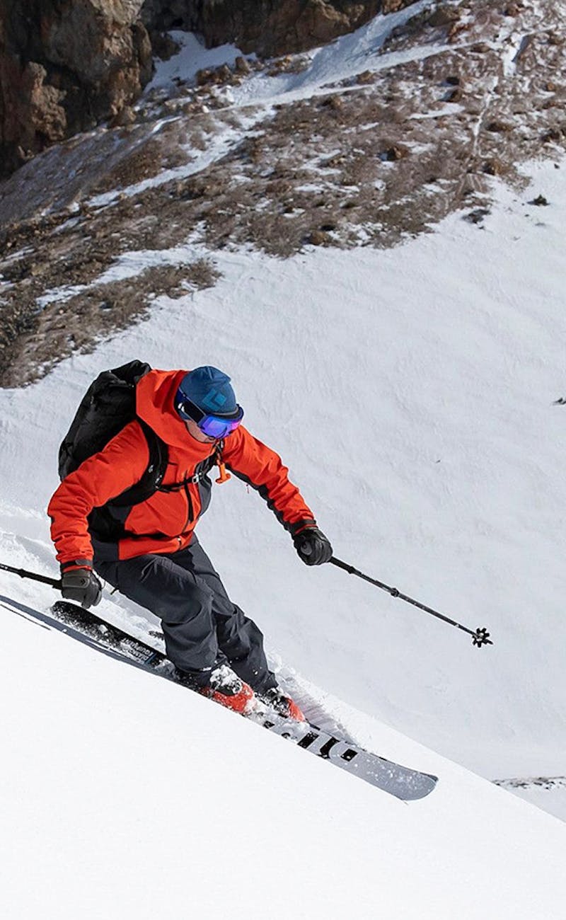 Man skiing down a mountain using Black Diamond gear