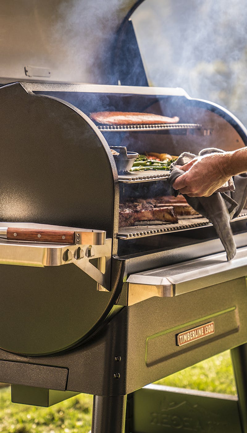 Close up of a man grilling in a Traeger Timerline 1300