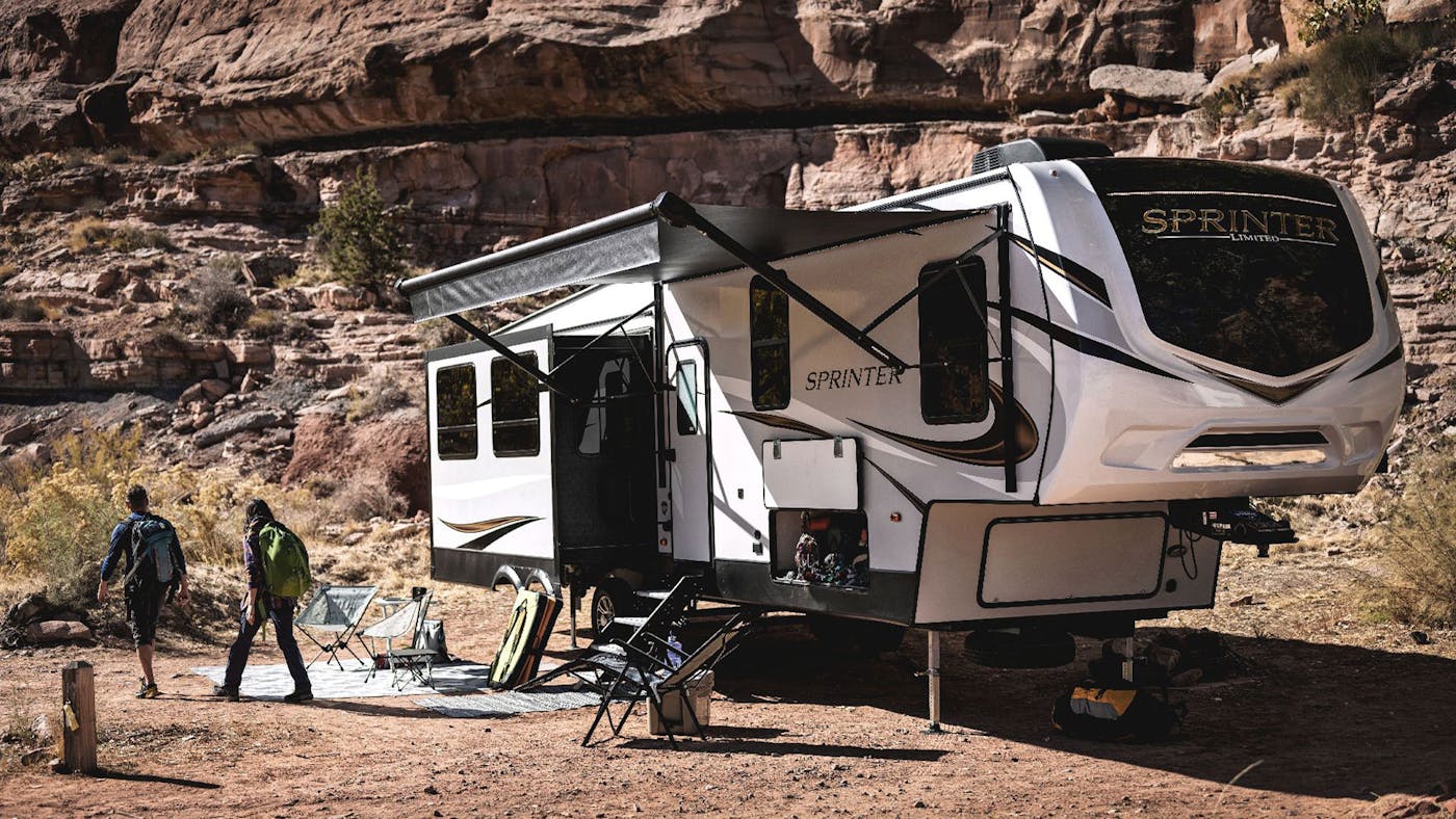 Keystone Sprinter RV with a couple walking next to it