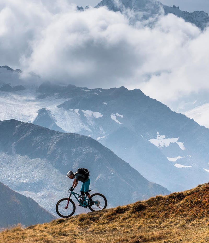 Two men riding Yeti bicycles in the mountains