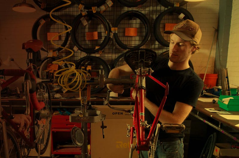Man fixing bicycle in a bike shop
