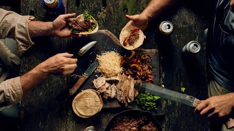 Several Buck Knives and a table of food