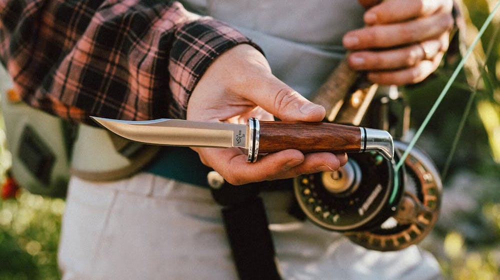 Person holding up Buck knife
