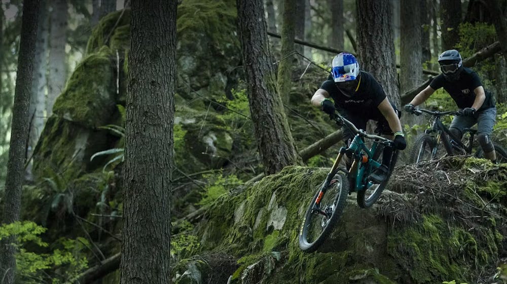 People riding bikes competing in the woods