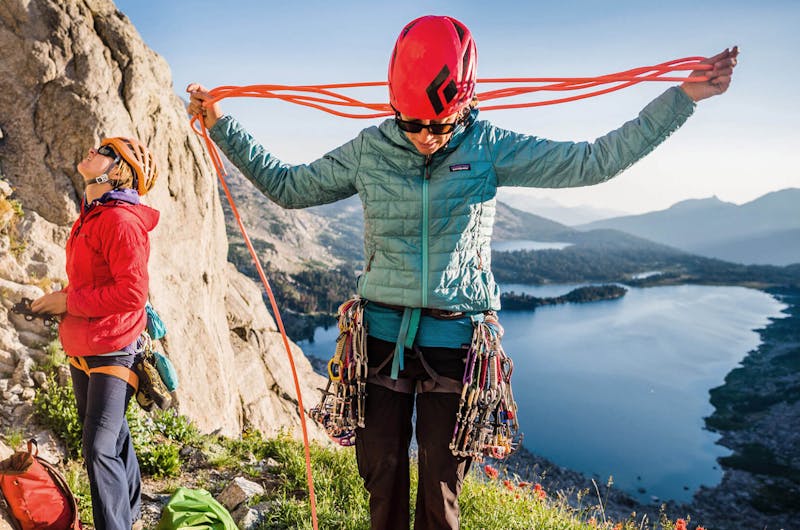 Women wearing Patagonia jackets and preparing to climb a mountain