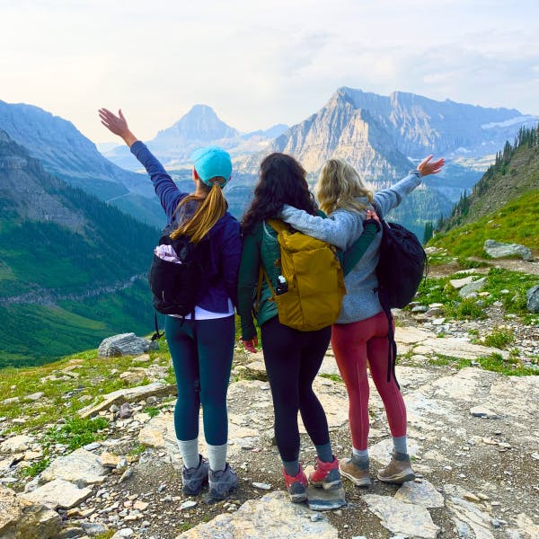 3 friends hiking with mountain backdrop