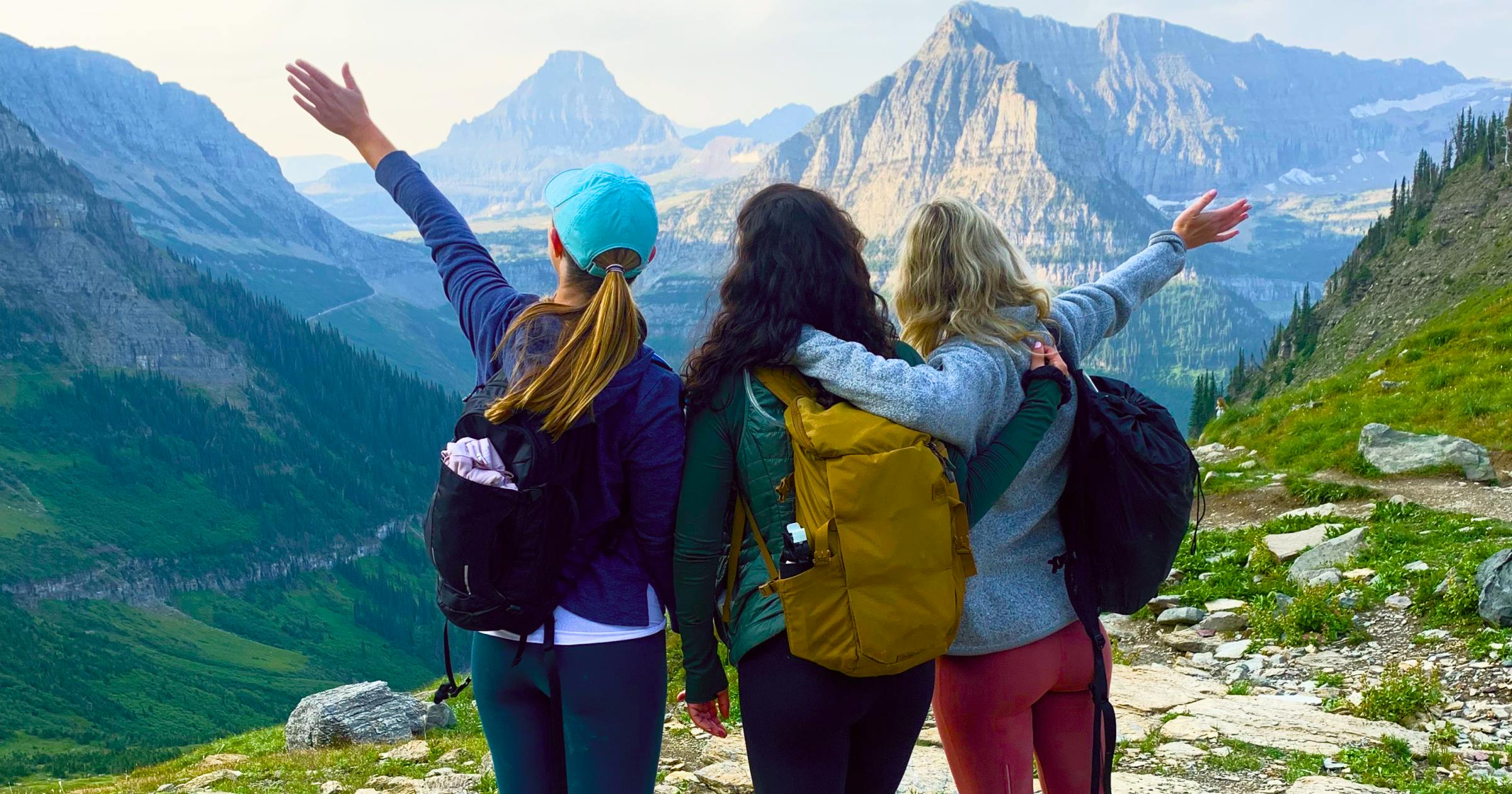 3 friends hiking with mountain backdrop